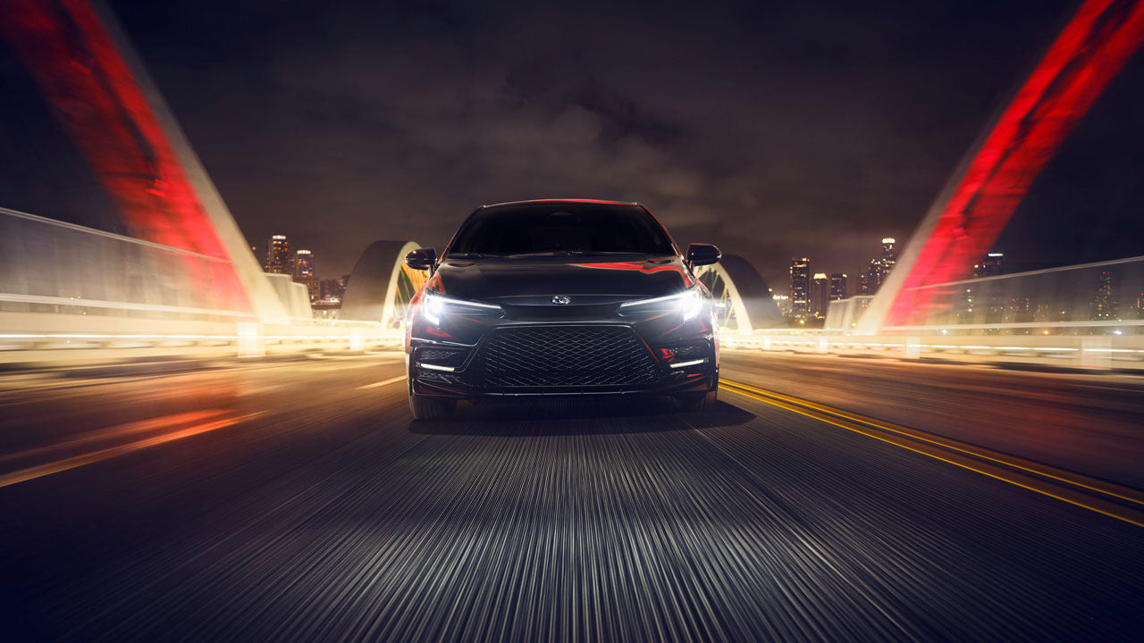 A 2024 Toyota Corolla Nightshade speeding along a bridge